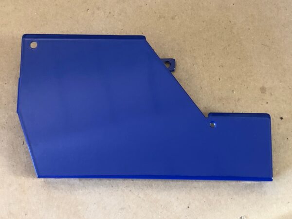 A blue plastic Control Cover Lid LEFT on a table.