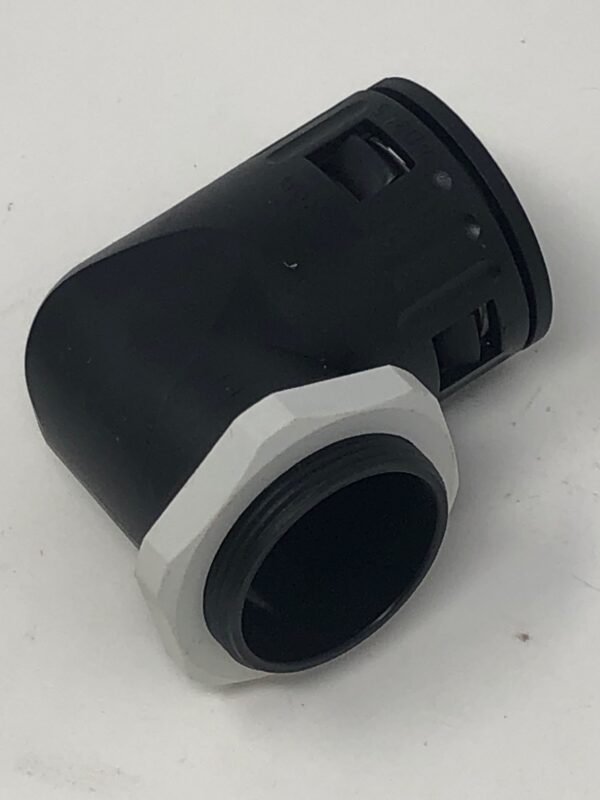 A black and white Connector 29 "L" Shaped fitting on a white surface.