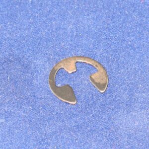 A metal E-ring on a blue surface.