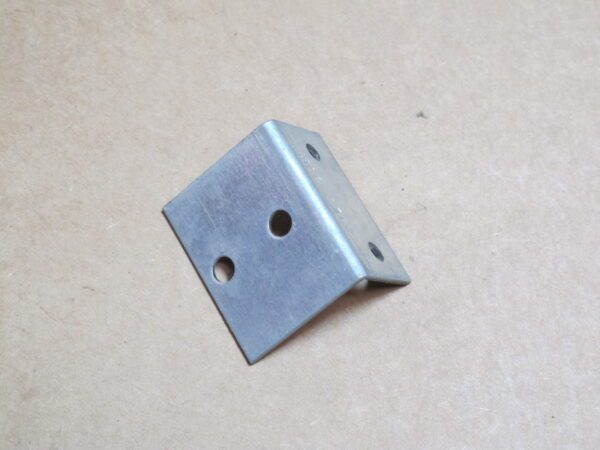 A Valve Bracket is a piece of metal with holes on it.