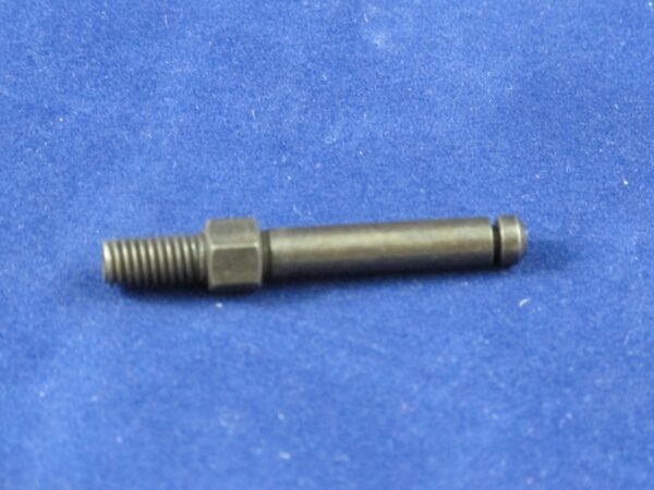 A black Actuating Pin bolt on a blue surface.