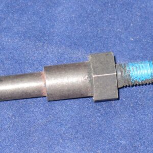 An Actuating Pin on a blue surface.