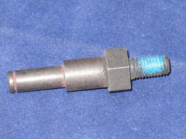 An Actuating Pin on a blue surface.