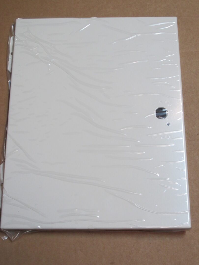 A white plastic Service Door sitting on a table.