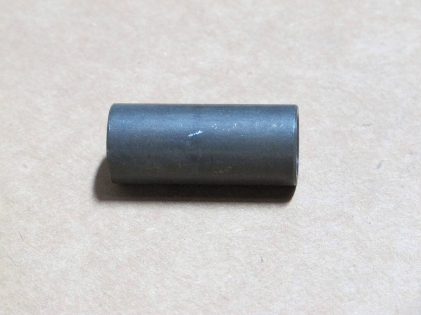 A small black Collar L on a table.