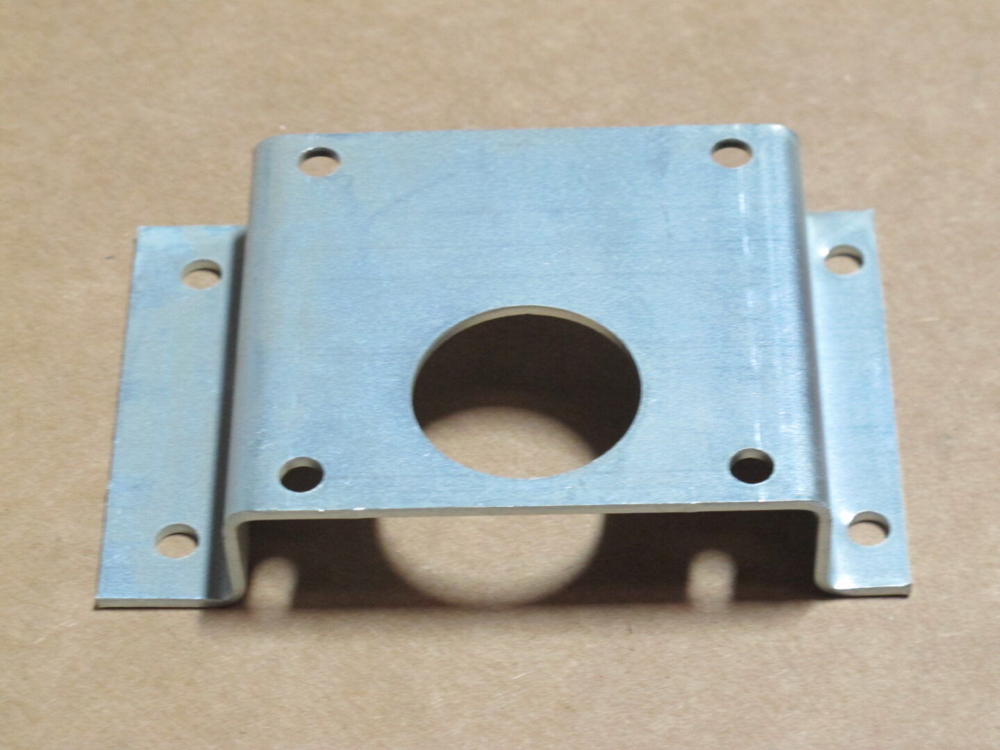 A Motor Bracket with holes on it.