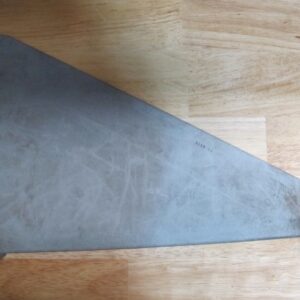 A triangular metal object on a wood surface.
