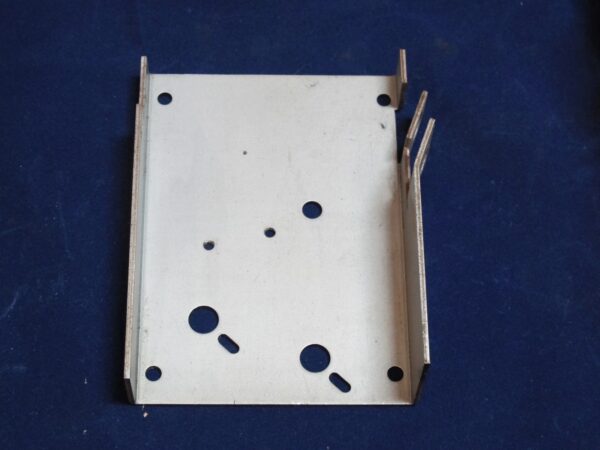 A metal bracket with holes on it.