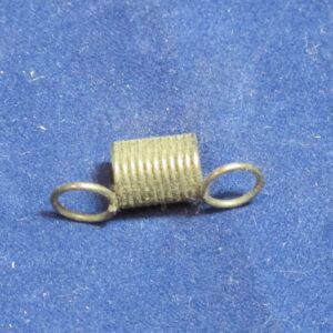A small Brake Spring on a blue surface.
