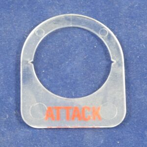 A plastic tag with the Attack Button Label on it.