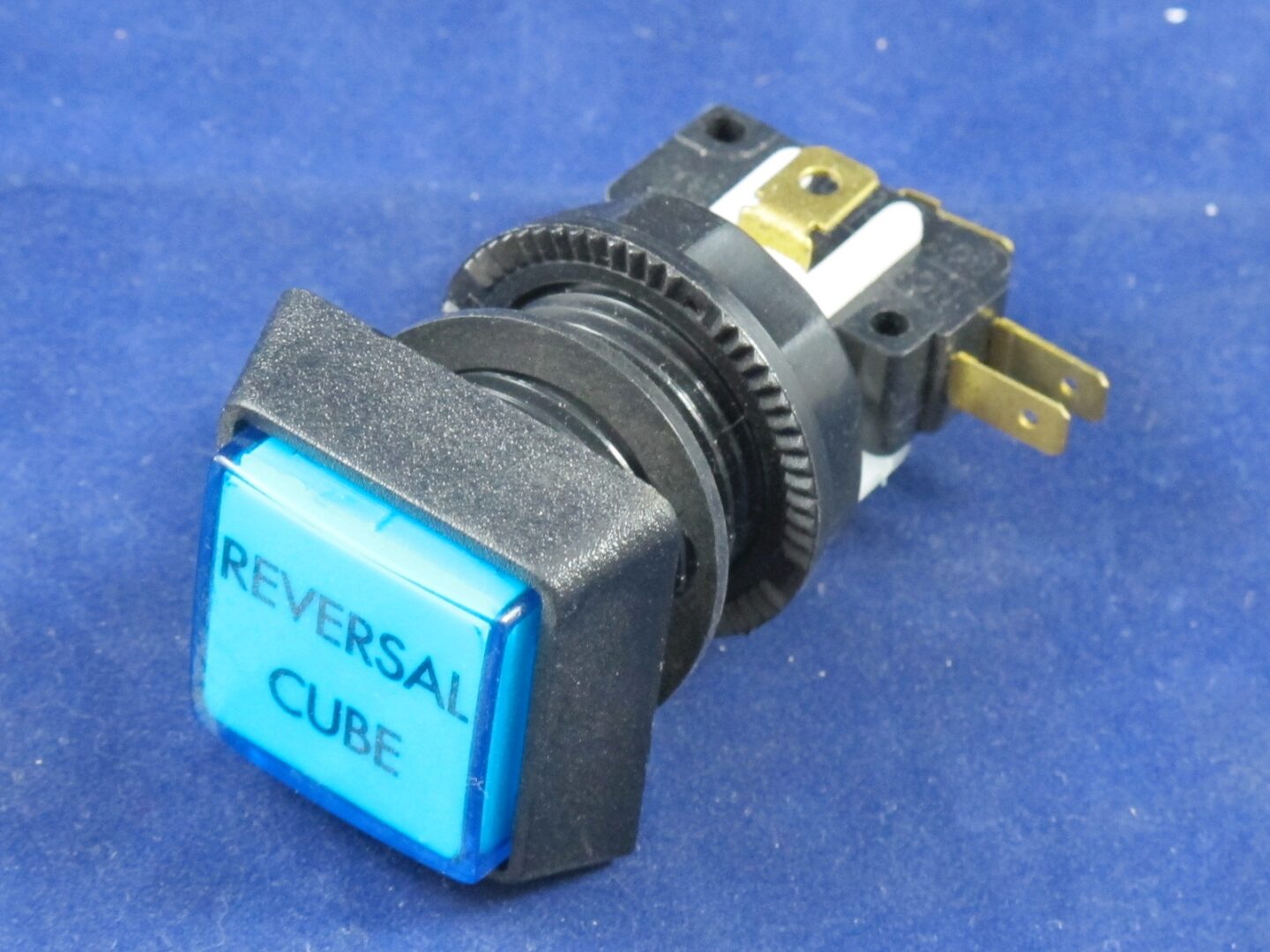 A blue Button Assembly, Reversal Cube with the words reverse cube on it.