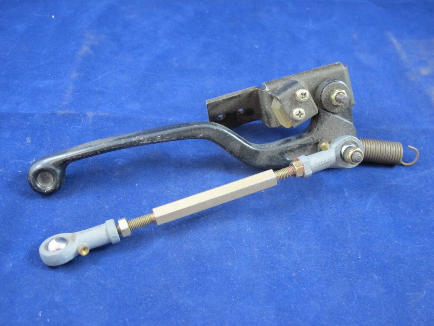 A motorcycle Brake Assembly on a blue surface.