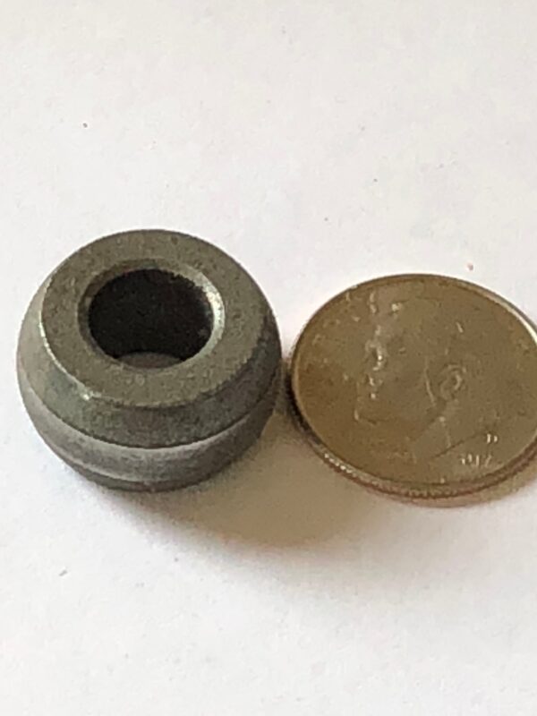 A metal round object next to a 20-9298.