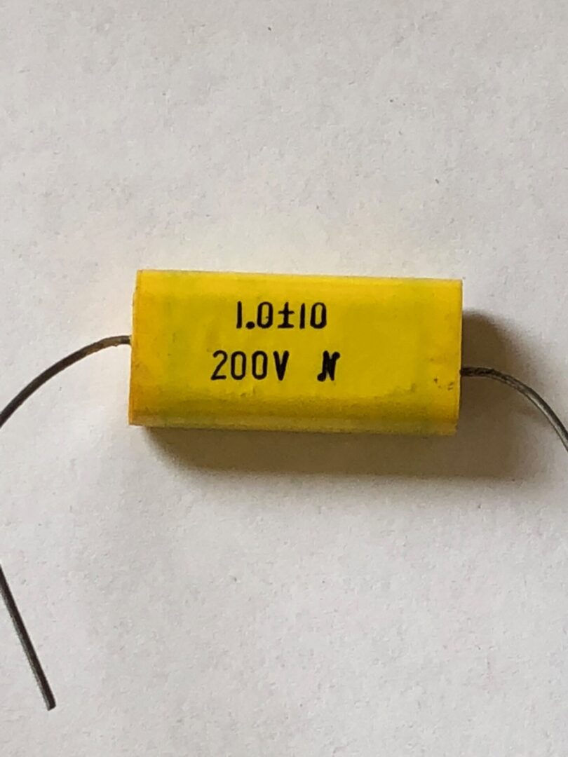 A 5A-8742 capacitor on a white surface.