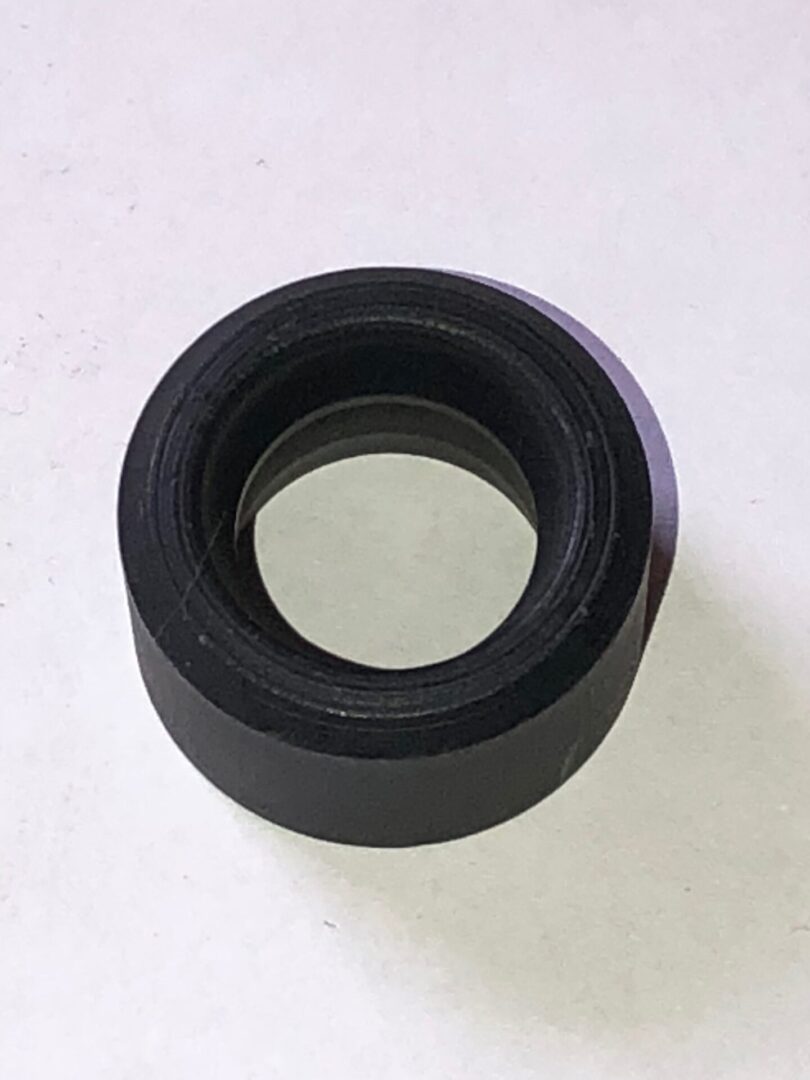 A black rubber ring on a white surface.