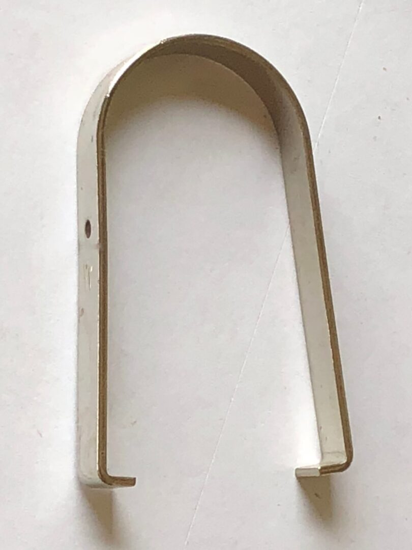 A piece of metal on a white surface.