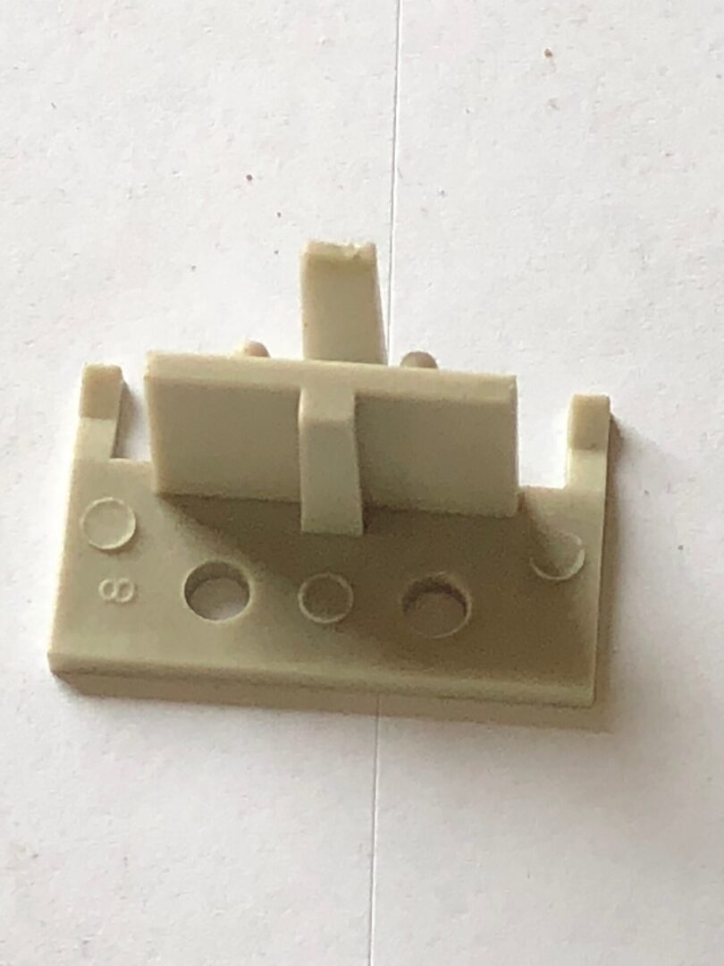 A plastic piece of electrical device.