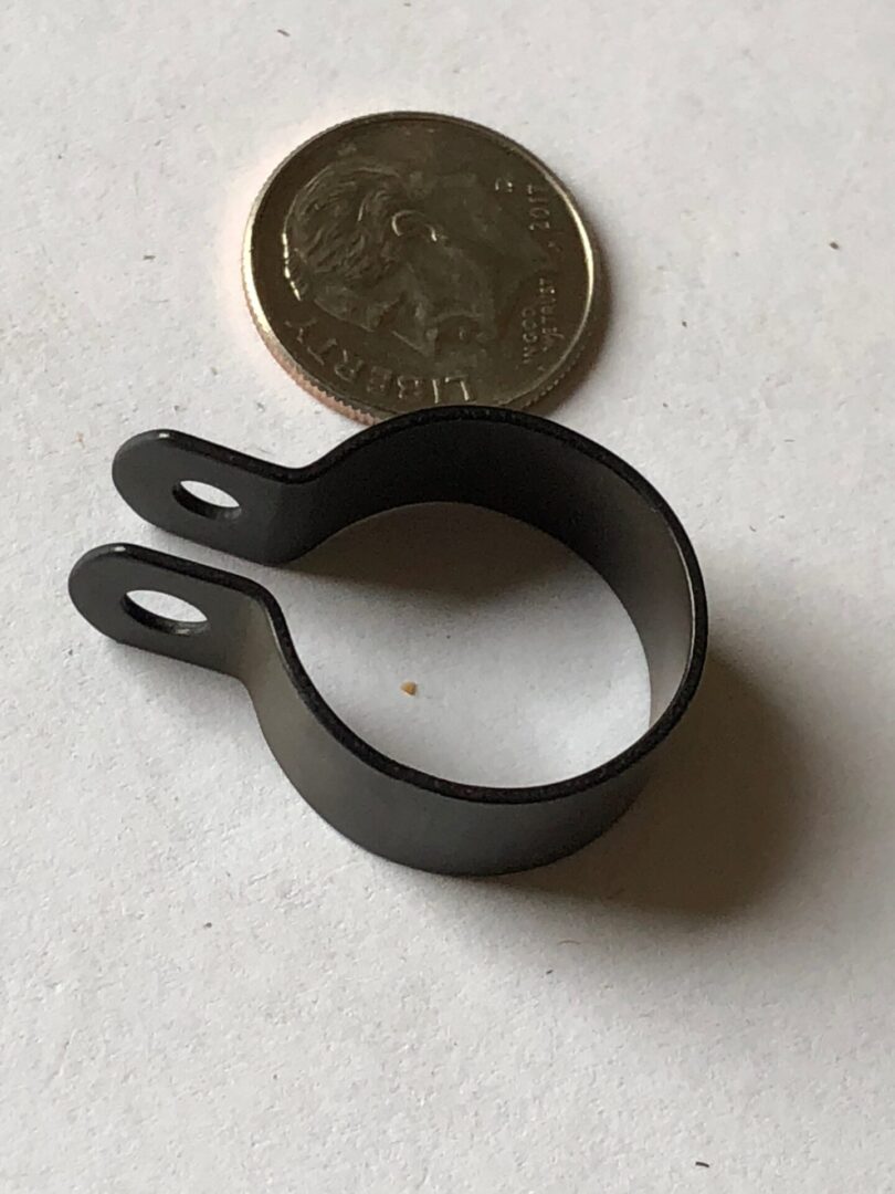 A small black metal ring with an on it.