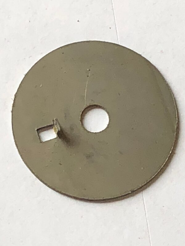 A circular metal object with a hole in the middle.