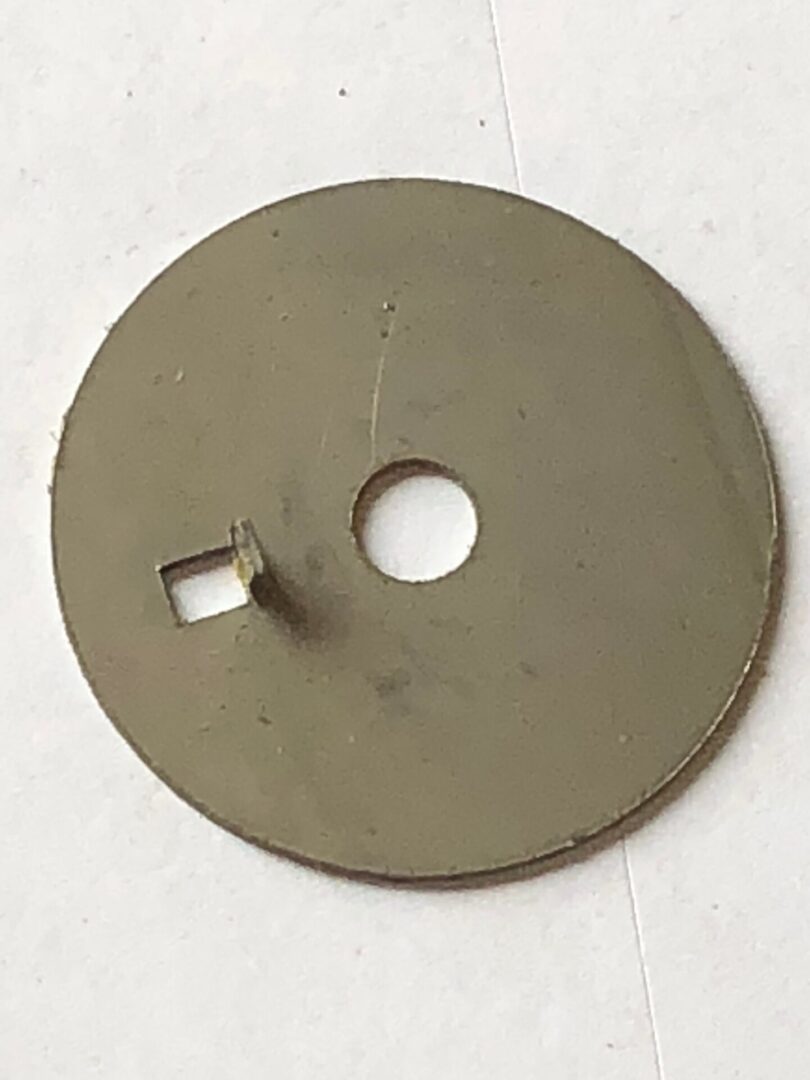 A circular metal object with a hole in the middle.