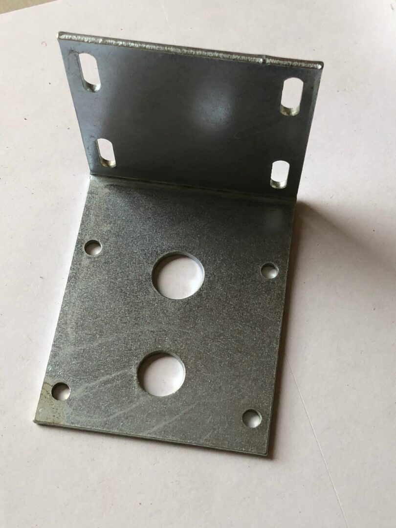 A metal object with two holes on it.