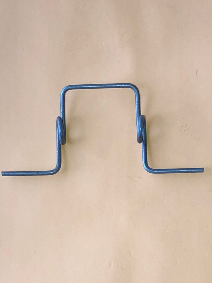 A pair of Wire Gate handles on a beige background.