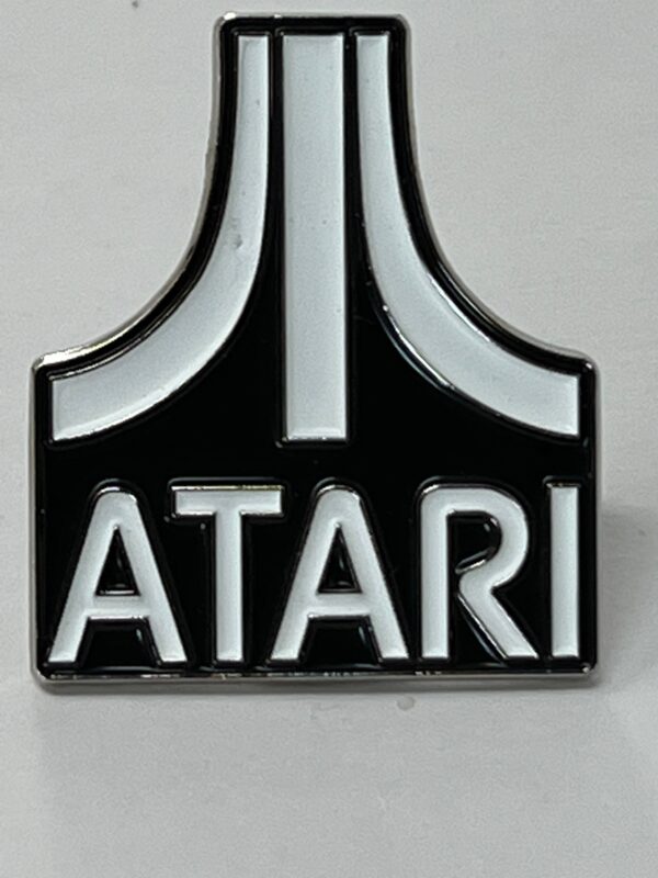 Atari Logo Glow-in-the-Dark Lapel pin on a gray background