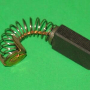 A small 601-6150 Motor Brush on a green surface.