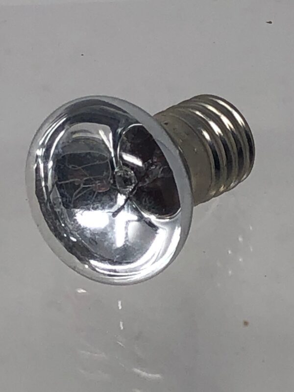 A silver Lamp on a white surface.