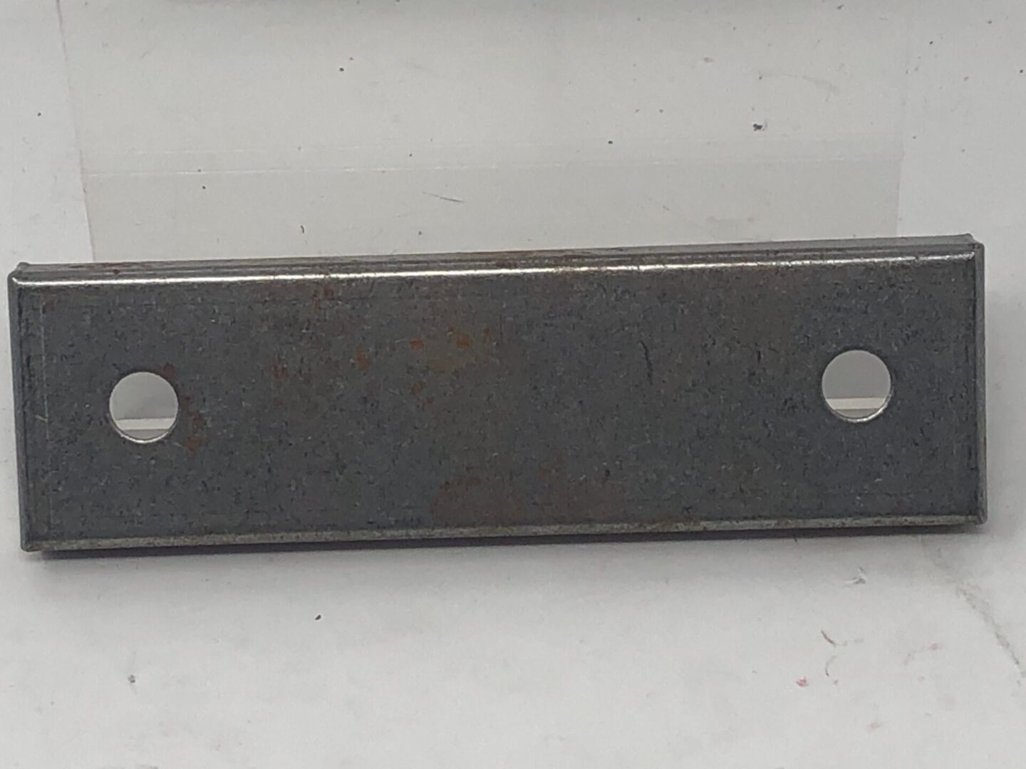 A Harley Deluxe Bearing Retainer with holes on it.