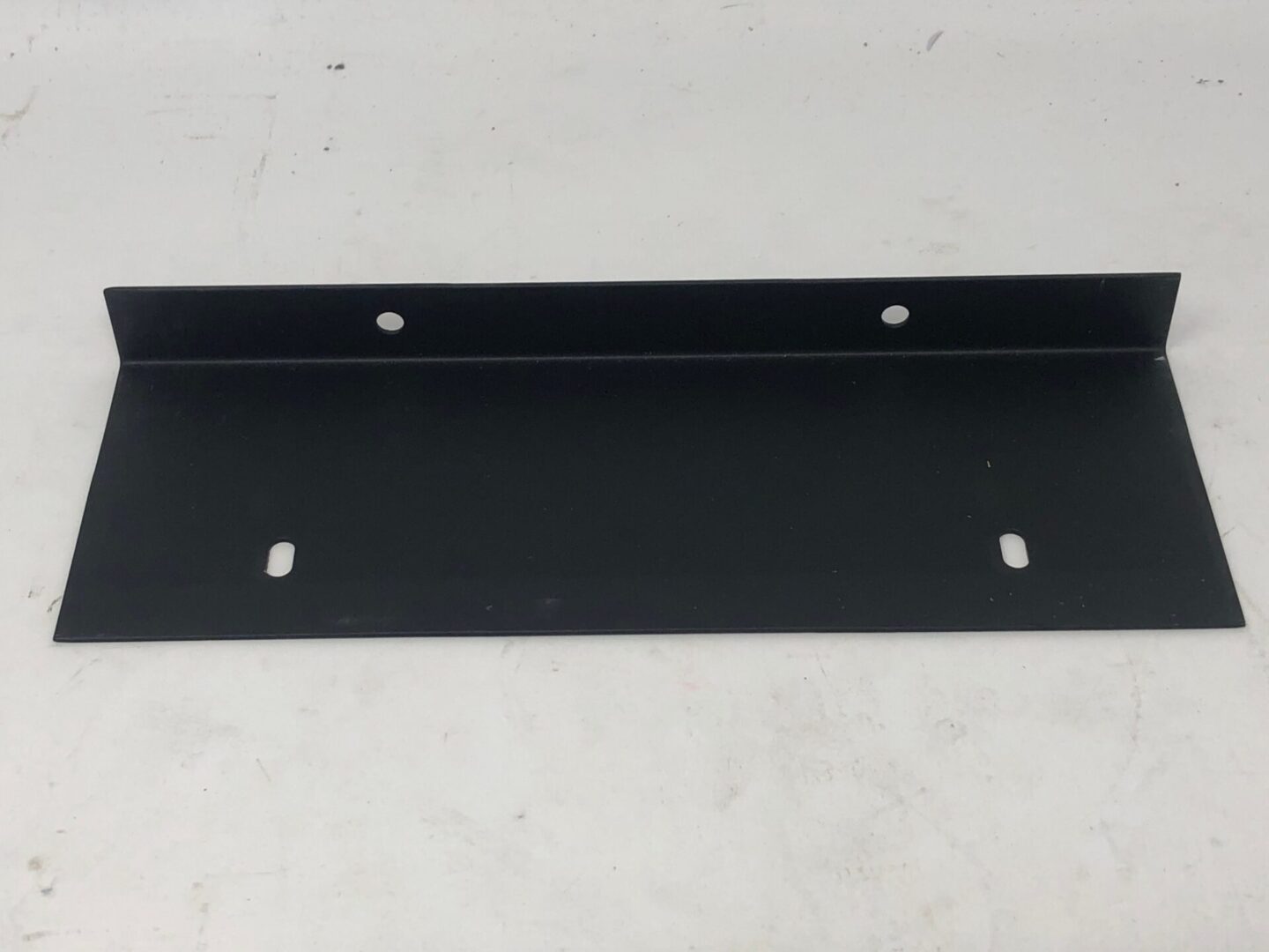 A black metal Foot Pedal Plate, Rear, Club Kart with holes on it.