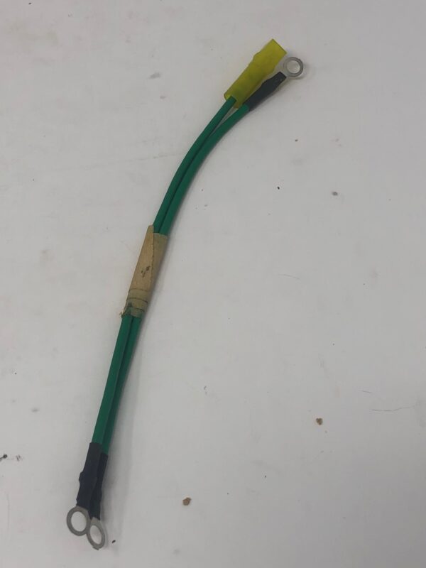 A green and black Wire Harness Ground, for electrical cable.
