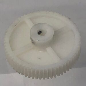 A white plastic Gear 64 on a white surface.