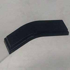 A black 260-3002 - plastic piece handle on top of a white surface.