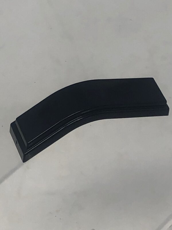 A black 260-3002 - plastic piece handle on top of a white surface.
