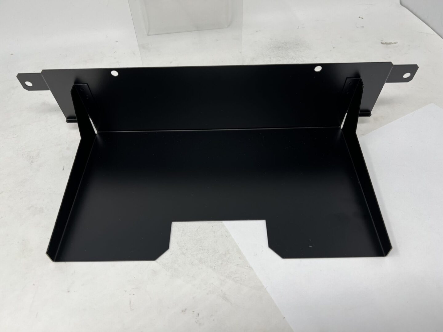 A black metal shelf for a Cover Plate, Daytona 2.