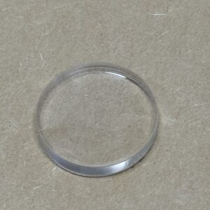 A transparent glass or plastic ring on a plain surface.